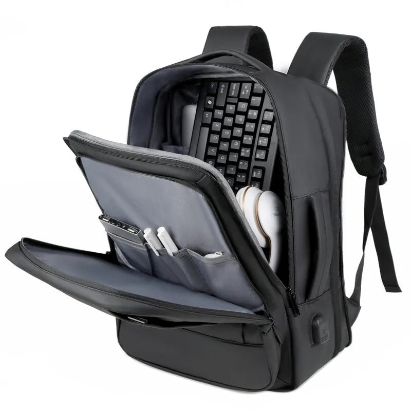 Large capacity men's backpack for outdoor travel with hand-carry handle and multifunctional business use, simple black or grey computer bag made from waterproof Oxford cloth with curved shoulder straps.