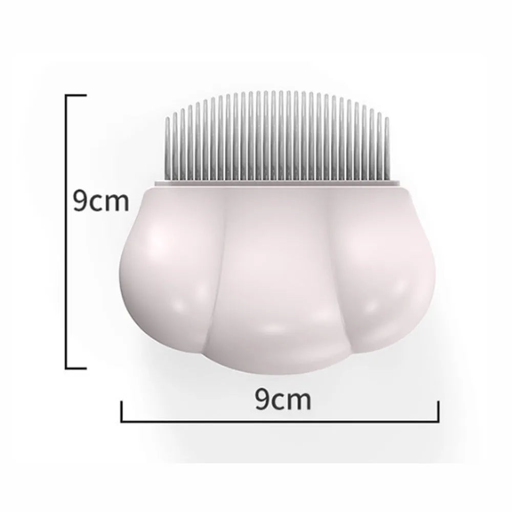 Paw Soft deshedding grooming brush in blue, pink, or white on a wooden table with pet fur.
