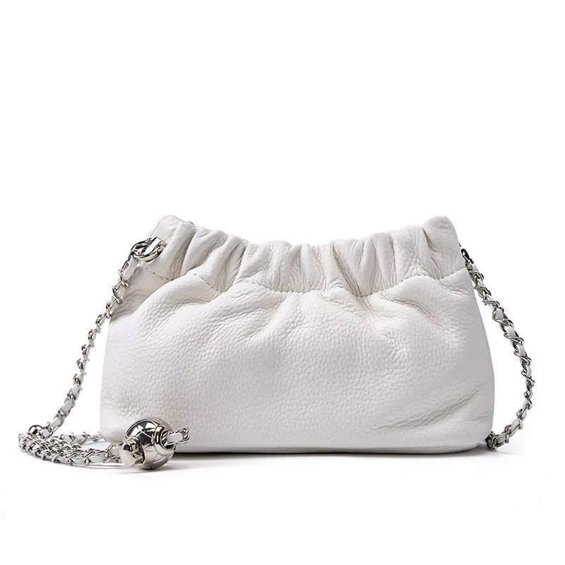 Women's dumpling-shaped genuine leather crossbody bag in three neutral colours showing slit pocket