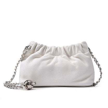 Women's dumpling-shaped genuine leather crossbody bag in three neutral colours showing slit pocket