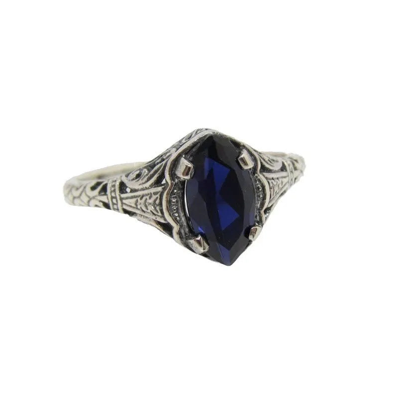 Silver women's ring with geometric hollow pattern and zircon detail on a finger.