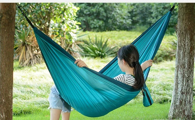 Premium double hammock made with soft, breathable fabric and reinforced ropes for outdoor use