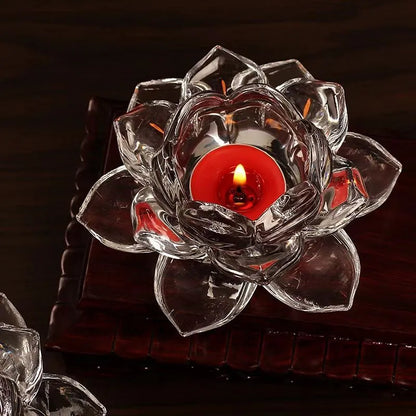 Glass lotus-shaped aromatherapy candle cup on a table.