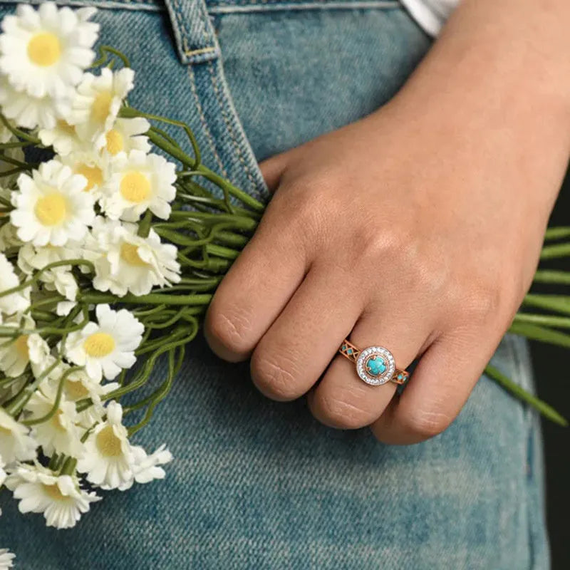 Rose gold copper women's ring with geometric design and inlaid turquoise zircon stones.