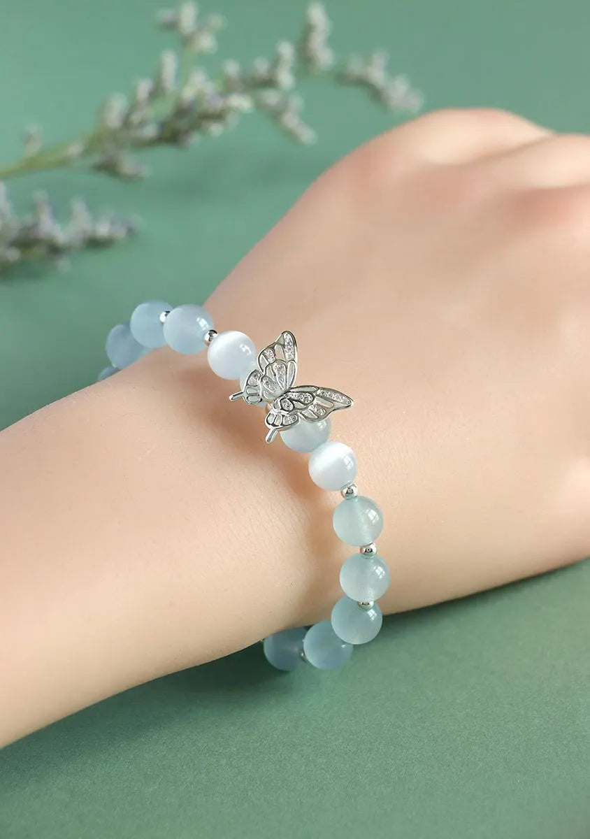 Women's crystal bow bracelet with butterfly design in ocean blue, pink, and purple colour options