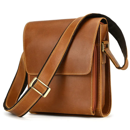 Men's brown first layer cowhide leather shoulder bag with crossbody strap and visible sewing line details.
