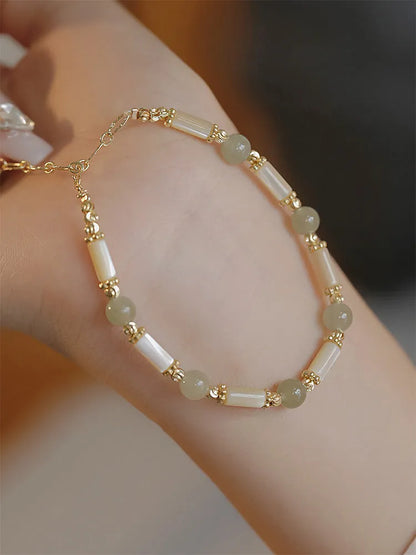 Women's Hetian jade bracelet with bamboo joint design on a white background.