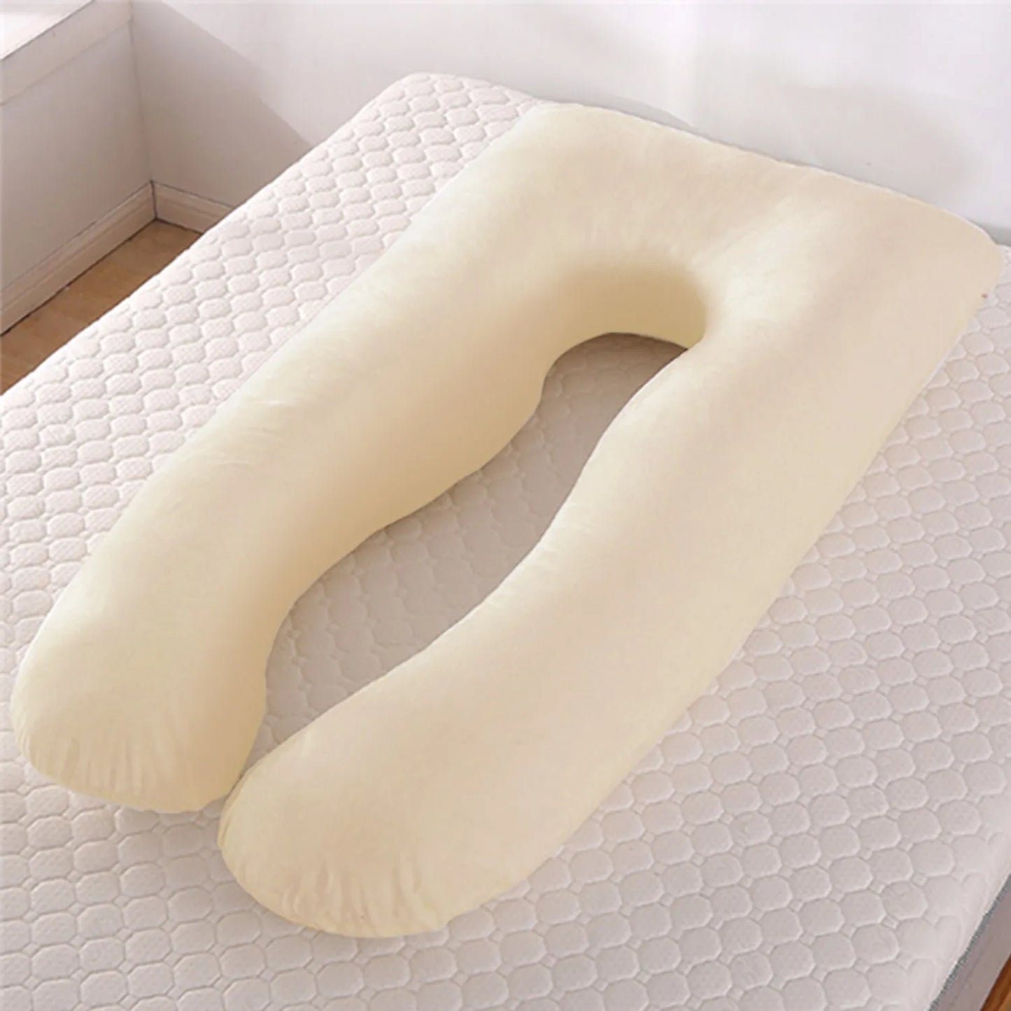 Light blue U-shaped ice silk maternity pillow for pregnancy support on a bed