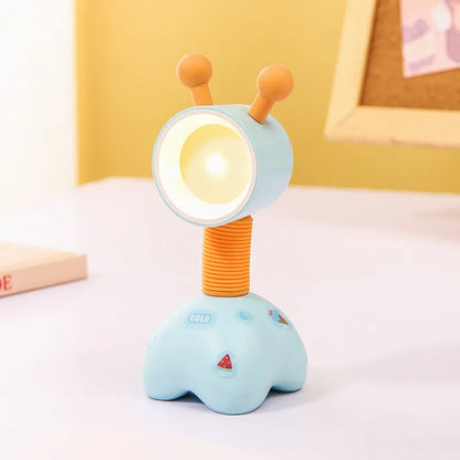 Colourful cartoon character magnetic DIY night light on a desk with adjustable head.