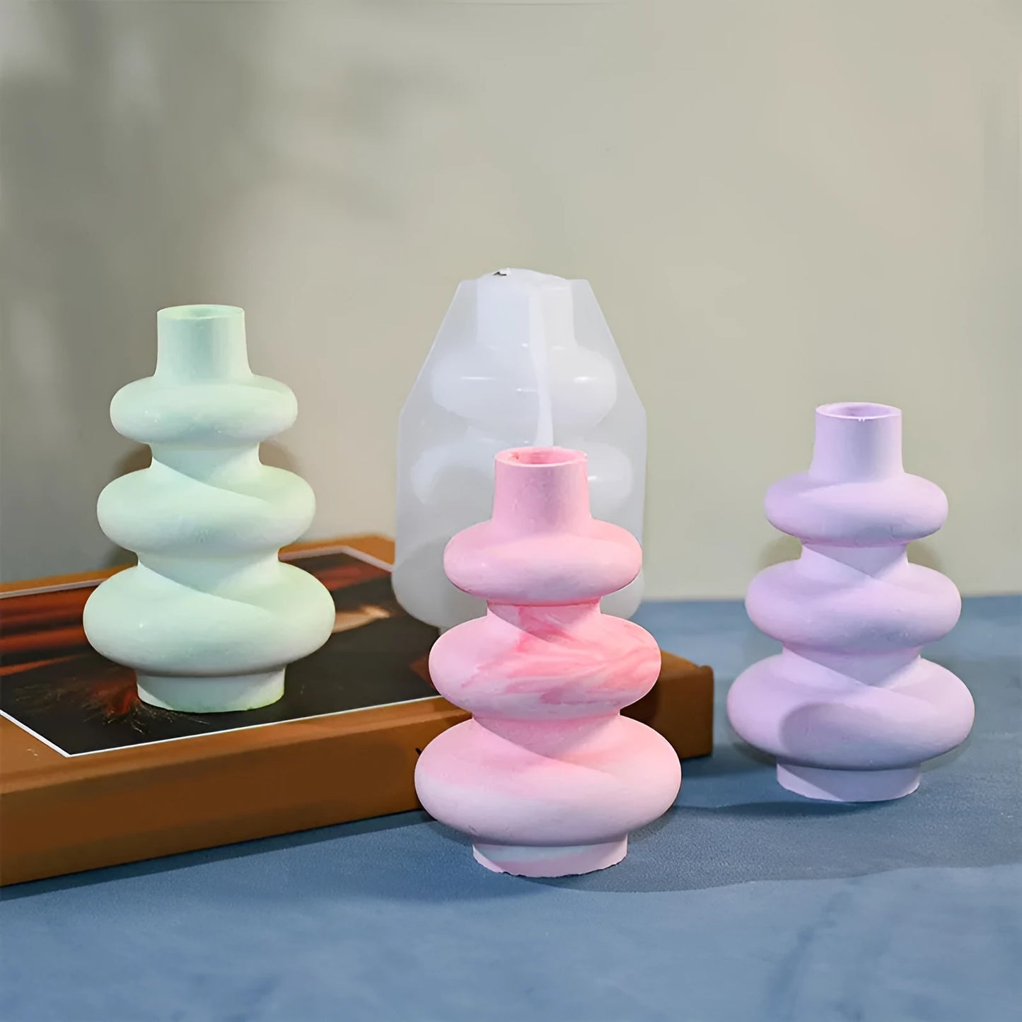 Silicone baking mould in shape of three-layer irregular circle vase on white background