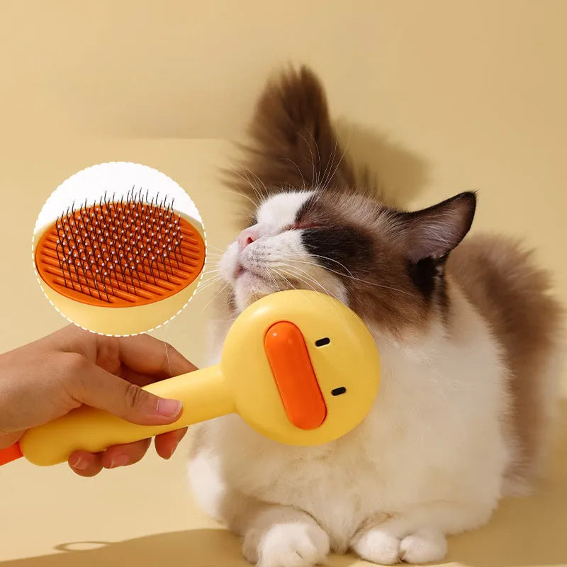 Small yellow duck-shaped plastic comb for grooming cats and dogs, with open needle teeth.