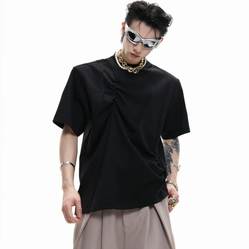 Men's loose fit black cotton T-shirt with textured pleats and asymmetric stitching detail.