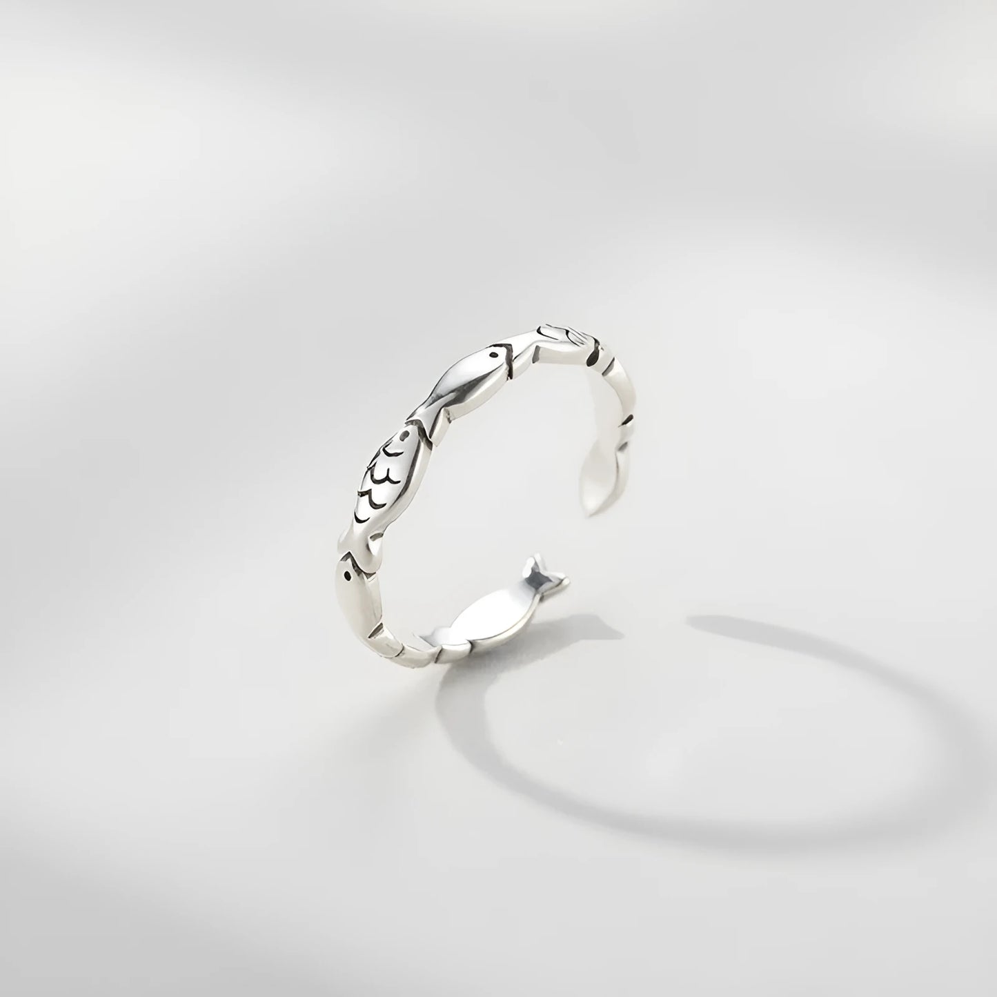 Women's adjustable sterling silver fish ring with detailed carp design on silver band