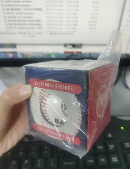 A green Bluetooth speaker shaped like a baseball with a USB port.