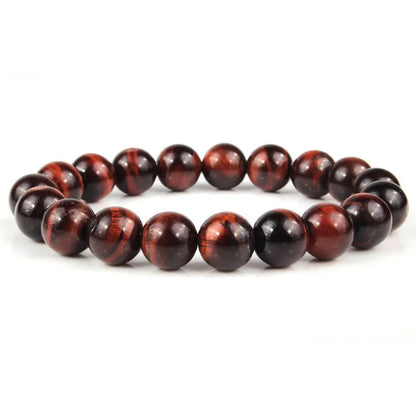 Natural tiger eye crystal bead bracelet showing round geometric beads on a wrist, available in multiple sizes and colour variations.