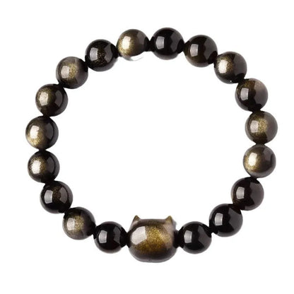Obsidian cat head bracelet with round stone beads and a gold-toned cat charm on a wrist.