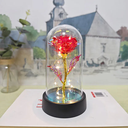 Glass cover small night lamp with plastic flowers, 15cm height, black base, showing colour light options