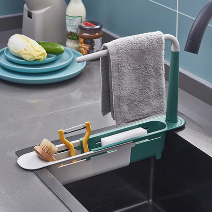 Telescopic plastic kitchen sink drain rack with multi-coloured modular baskets.
