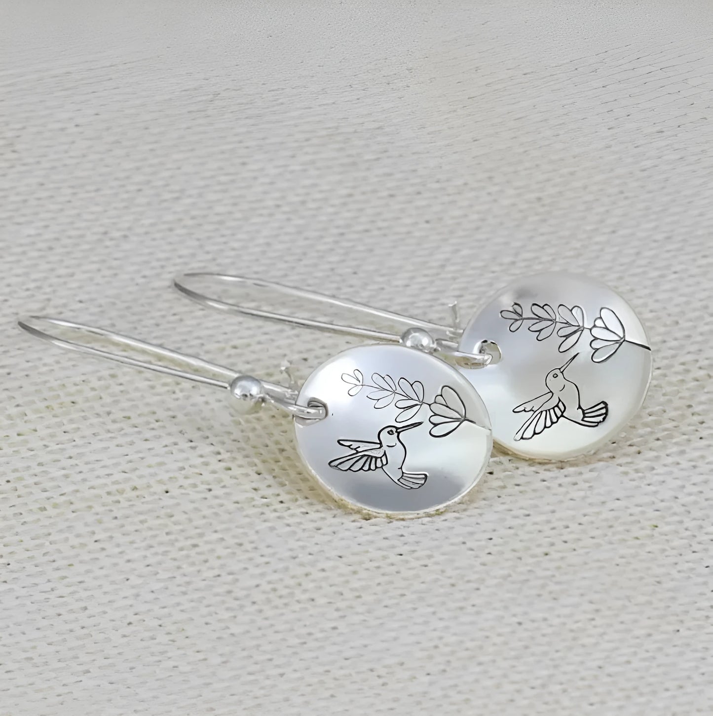 Silver zinc alloy women's earrings with glossy round shape featuring bird and flower designs