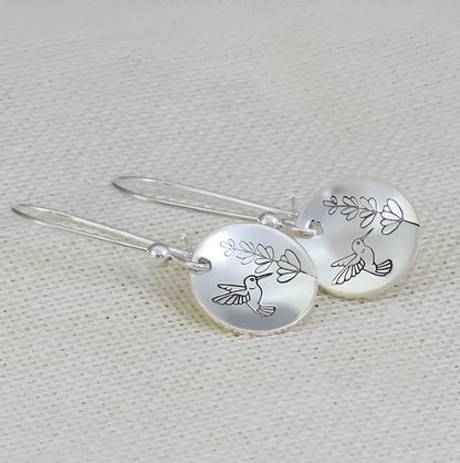 Silver zinc alloy women's earrings with glossy round shape featuring bird and flower designs