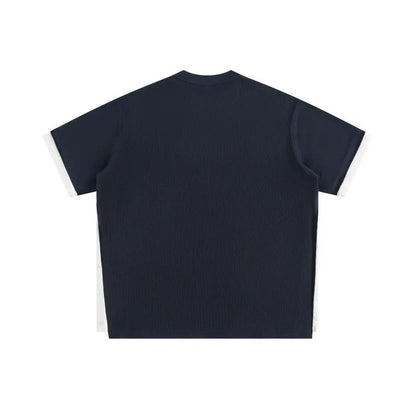 Loose fit waffle fabric T-shirt with retro alphabet embroidery on the chest, shown in navy blue.