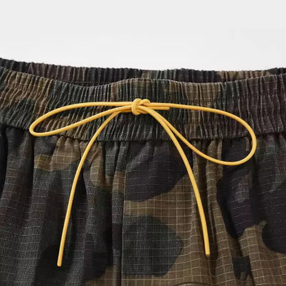 Green H215 washed camouflage cotton workwear shorts on a mid-waist, loose-fit model
