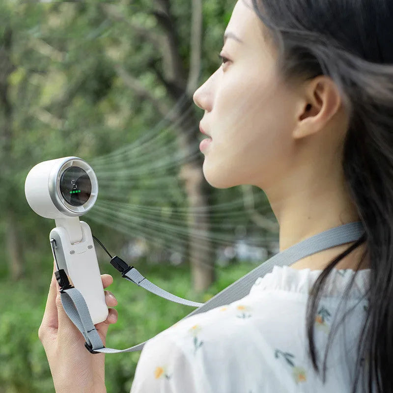 Portable folding mini fan showing adjustable head and compact plastic housing with USB Type-C charging port