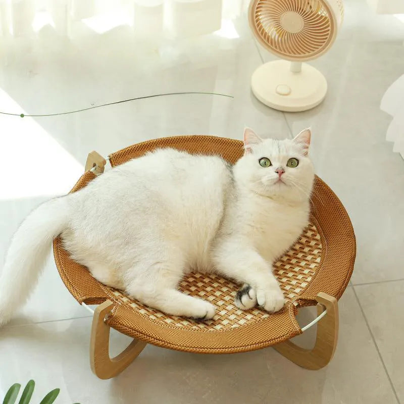 Brown woven rattan pet hammock bed for cats and small dogs on a flat surface.