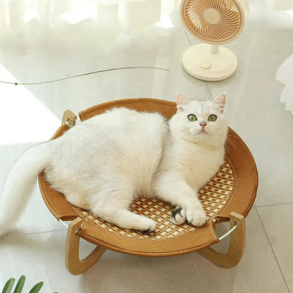 Brown woven rattan pet hammock bed for cats and small dogs on a flat surface.