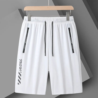 Man wearing black loose-fit quick-dry nylon sports shorts with an elastic waistband.