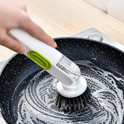 White and red long-handle kitchen brush with soap dispenser button and two interchangeable scrub heads on a hook.