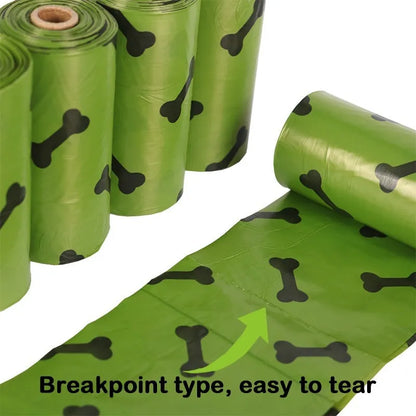 Roll of military green degradable dog poop bags with black bone print, shown next to a plastic dispenser.