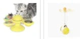Cat playing with rotating windmill toy featuring luminous balls and suction base