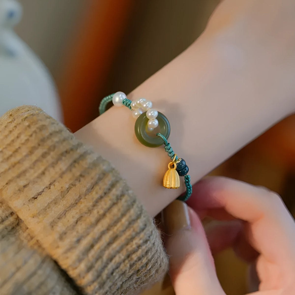 DIY hand-woven watch band with a Pearl Peace Buckle and pearl decoration on a white background.