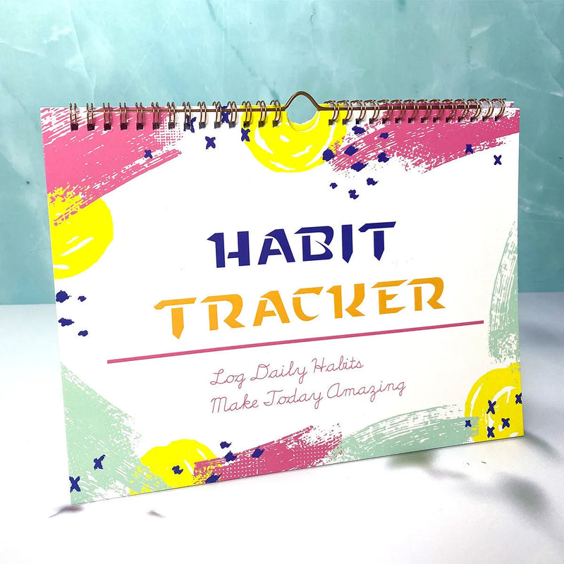 Habit tracking device and self-discipline clock-in planner book with 12 internal pages for schedule recording and goal planning, available in flower white, pink white, purplish white, and yellow and white colours, measuring 21cm by 28cm.