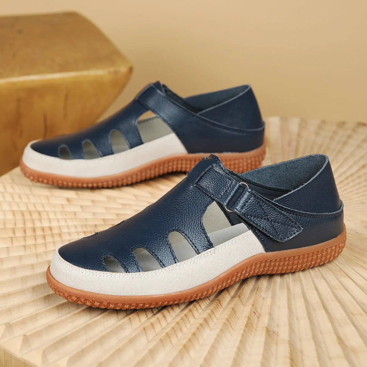 Plus size women's flat sandals with toe cap, hollow design, and thick rubber sole in blue.