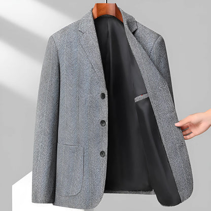 Man wearing a simple, loose-fit solid-colour casual coat in a neutral shade.