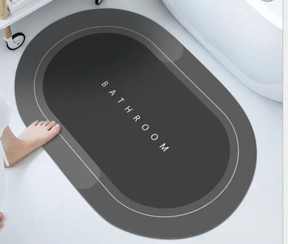 Oval diatomite bathroom floor mat in blue with natural rubber non-slip backing on tiled floor.