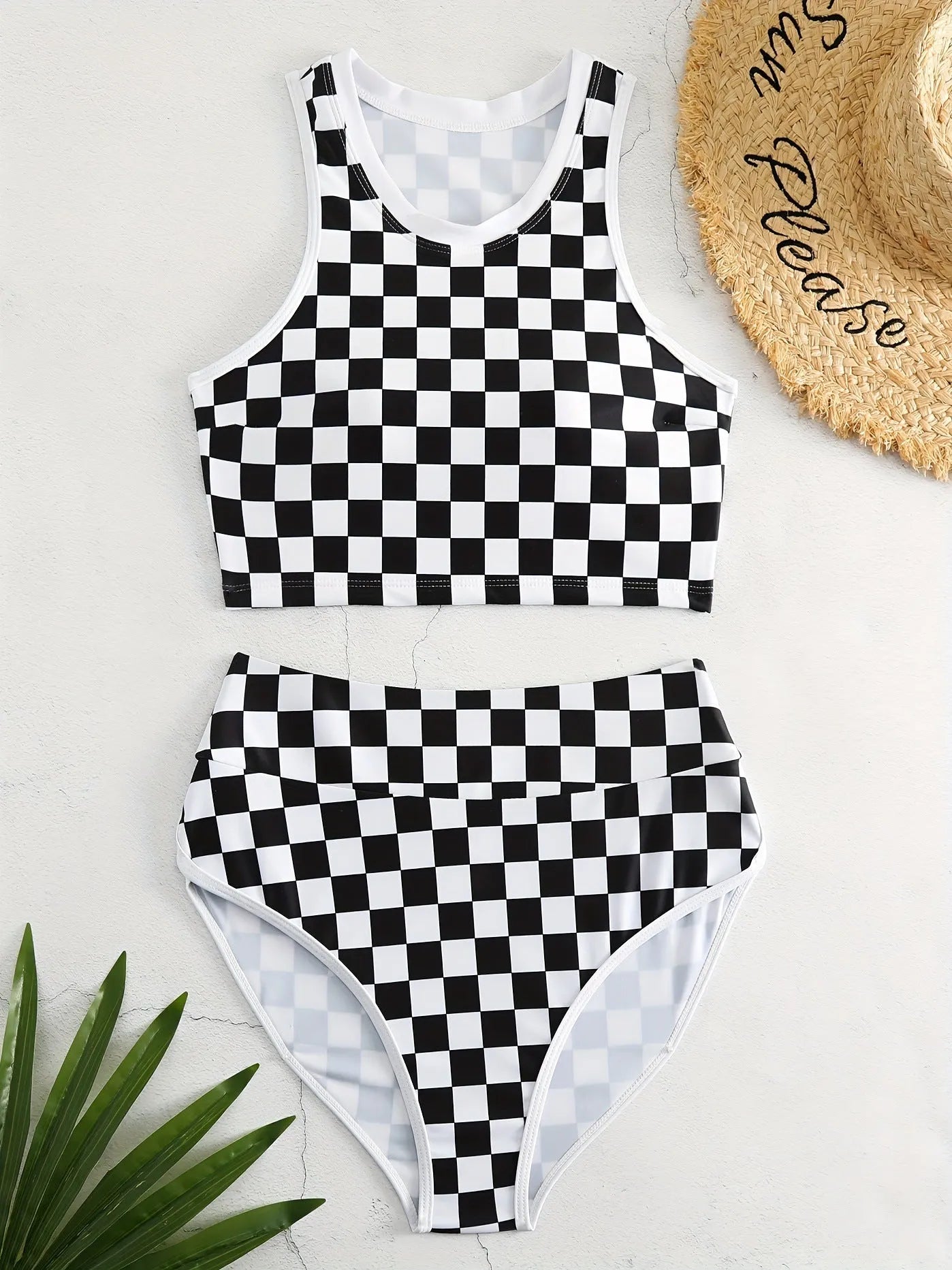 Women's checkerboard print backless one-piece swimsuit with suspender straps for swimming.