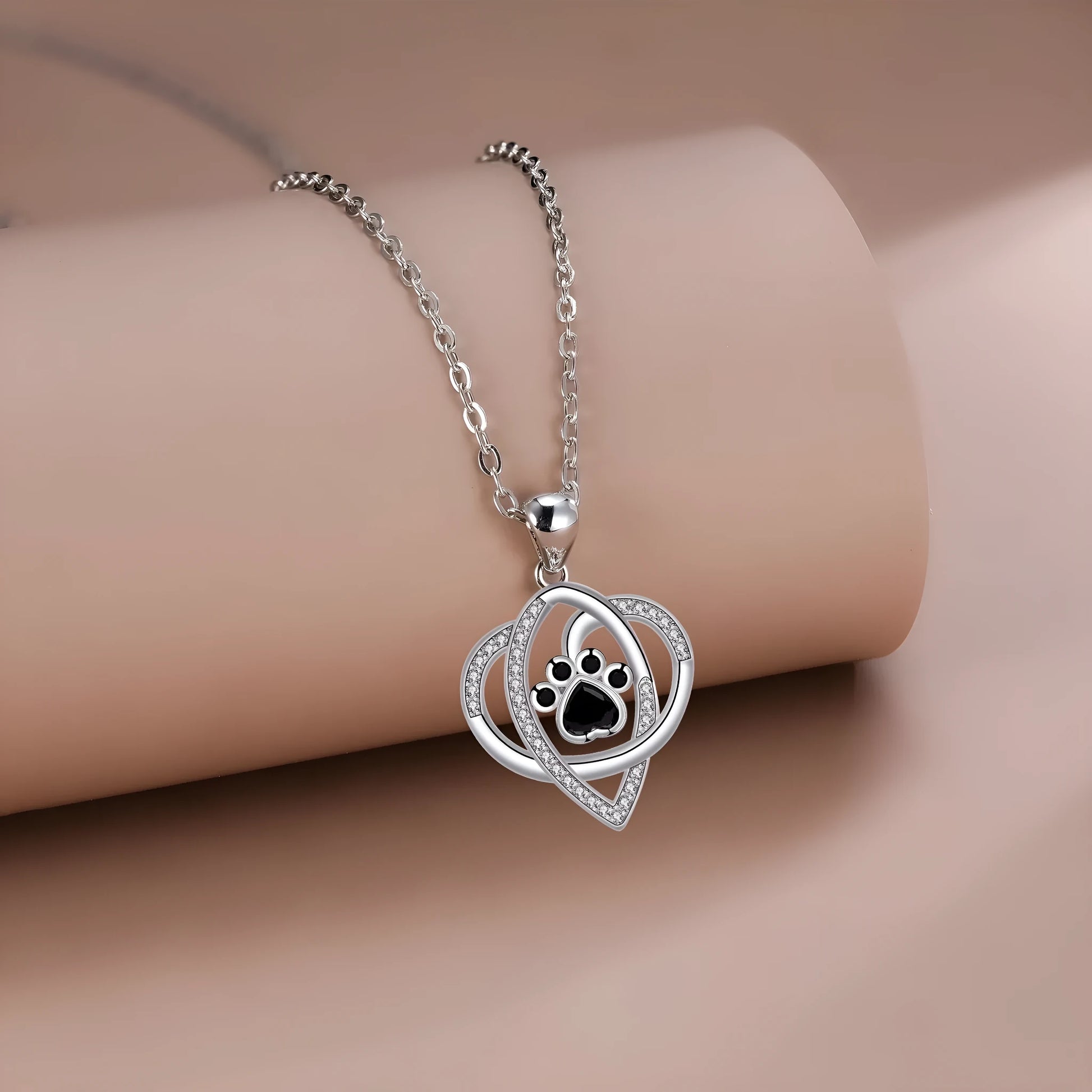 Women's necklace with dog and cat paw print designs on electroplated copper pendant