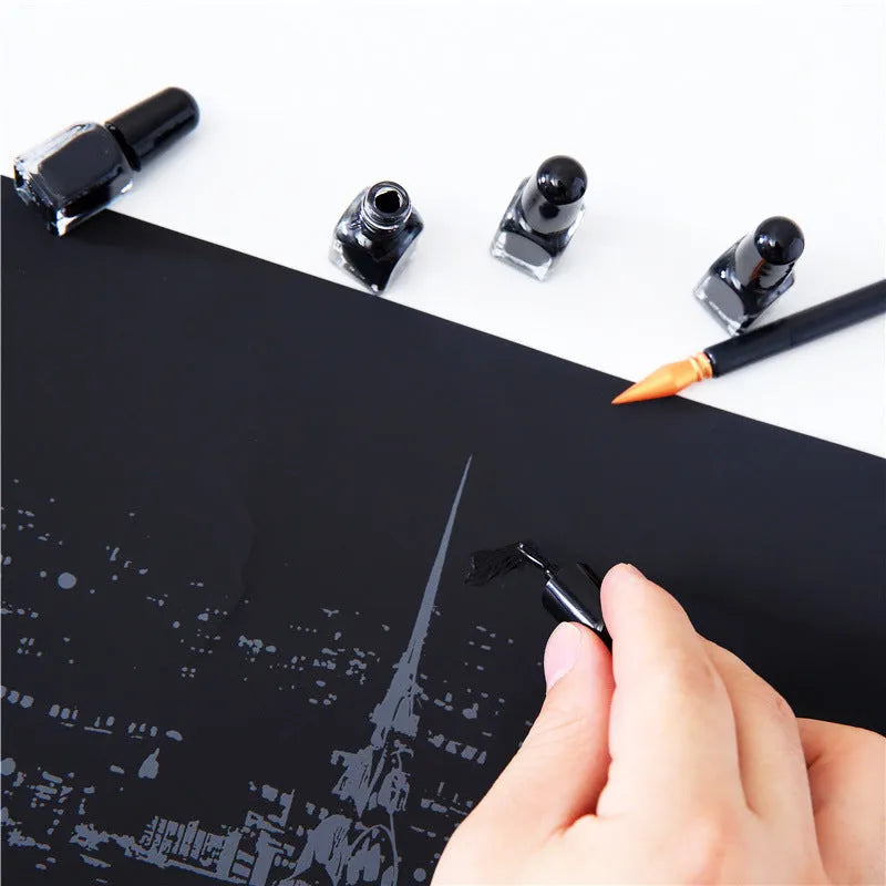 Diamond painting repair tool set with metal scraper pen, bottle of adhesive liquid, soft brush, and bamboo stick on a craft table