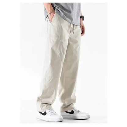 Beige cotton wide-leg trousers with an elasticated waistband laid flat.
