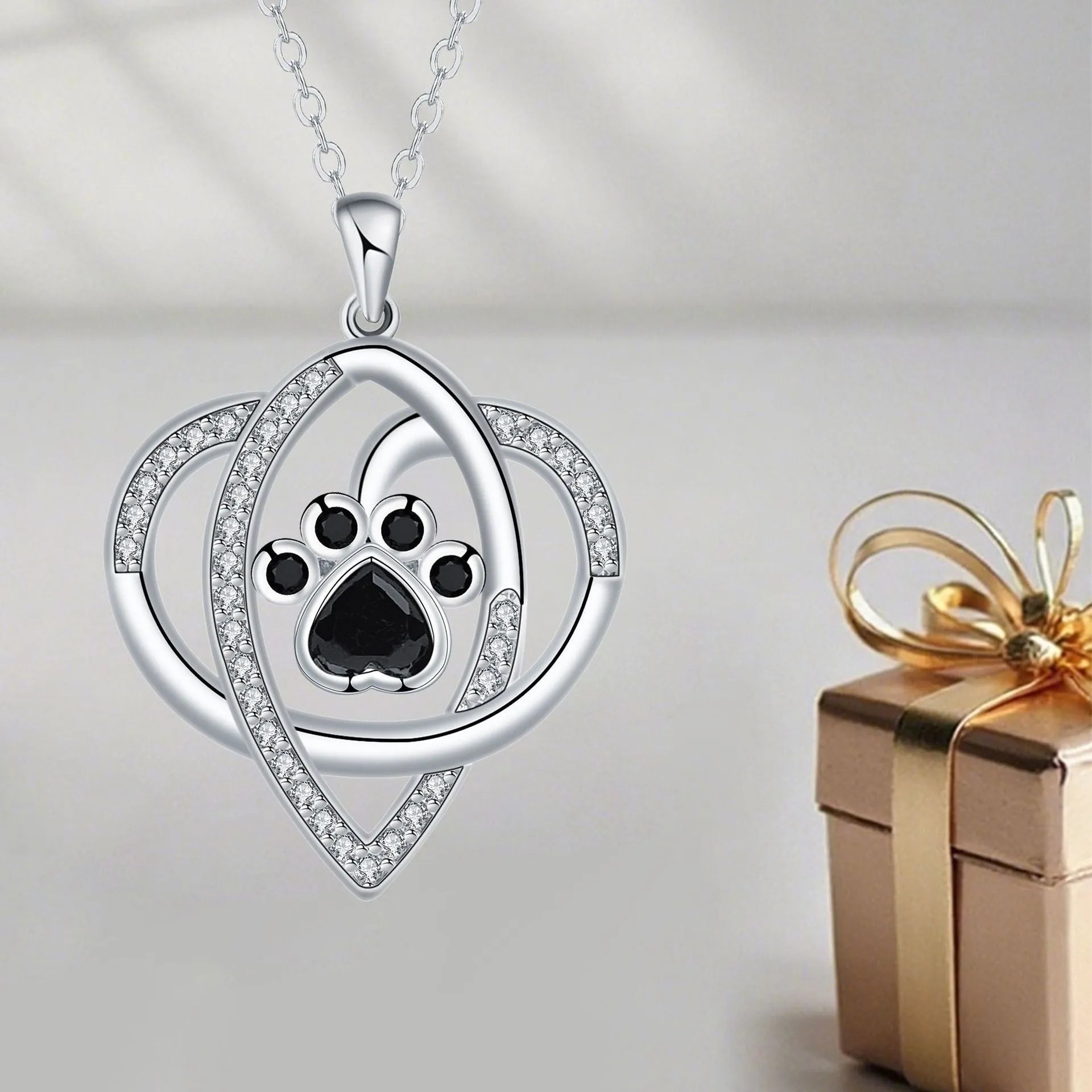 Women's necklace with dog and cat paw print designs on electroplated copper pendant