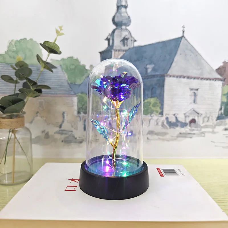 Glass cover small night lamp with plastic flowers, 15cm height, black base, showing colour light options
