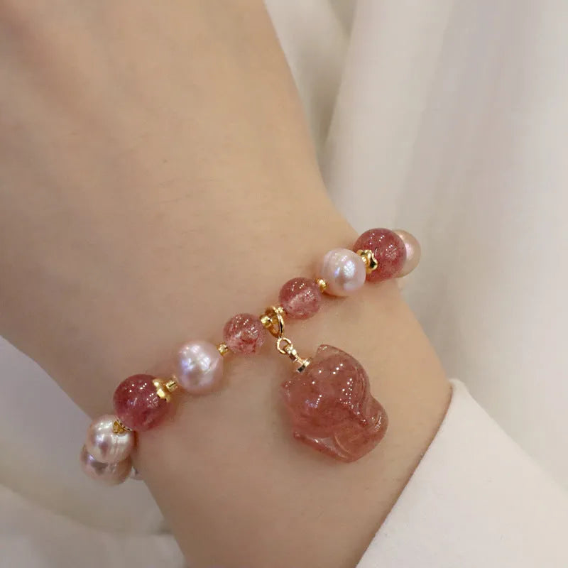 Women's light pink freshwater pearl bracelet with strawberry quartz stones and fox charm