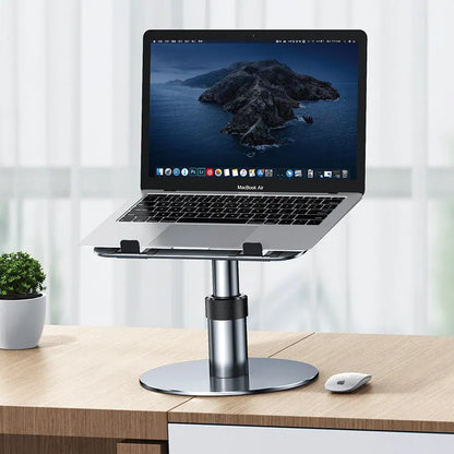 Silver adjustable aluminium car laptop stand with rotating base shown supporting a laptop.