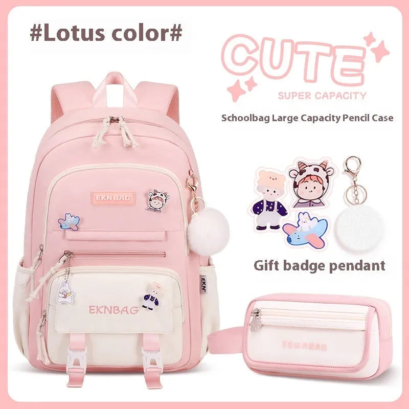 Pink waterproof school backpack for girls with curved ergonomic shoulder straps, shown with matching pencil case.