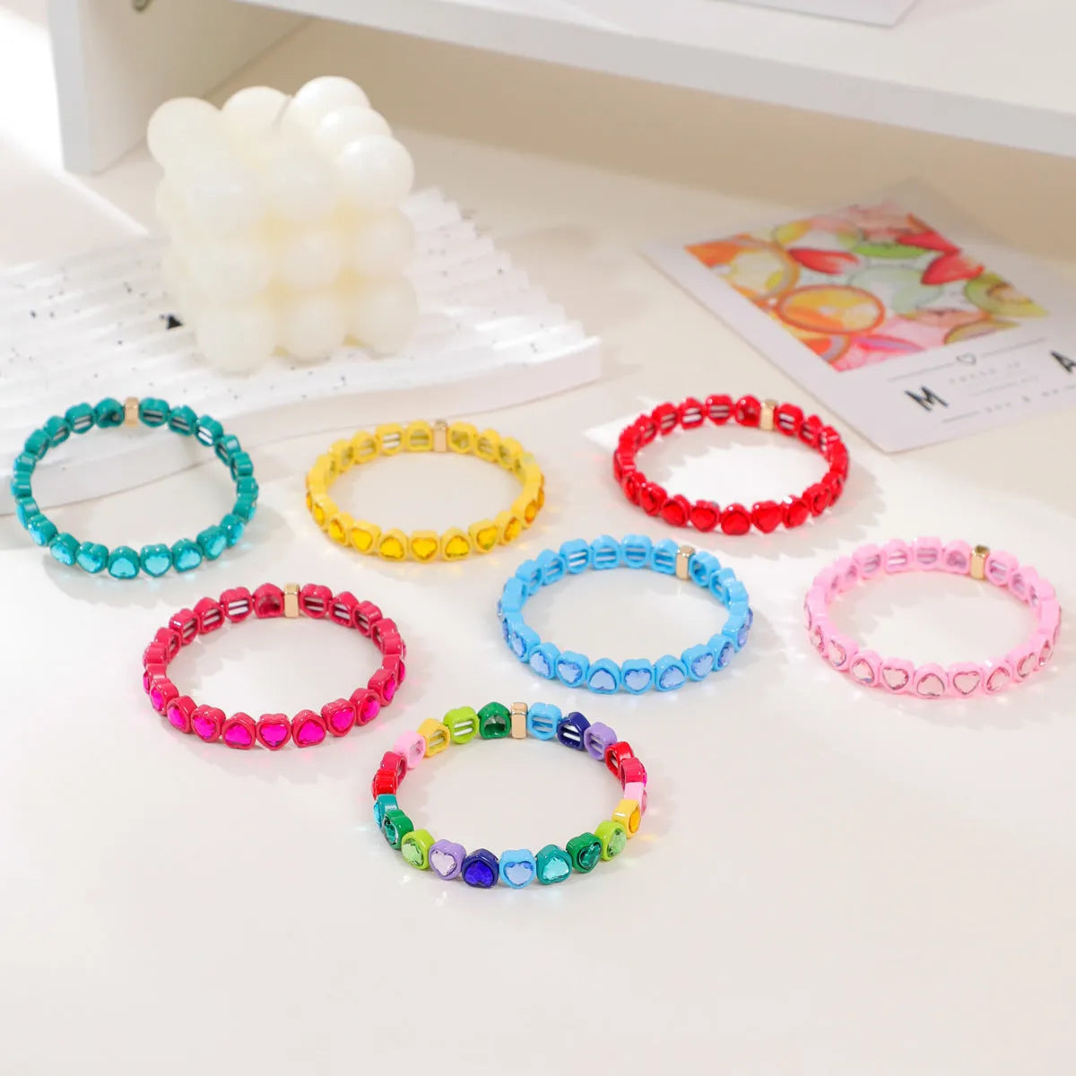 Colourful enamel heart shape on a silver-toned alloy stretch bracelet.