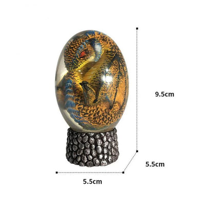A lifelike resin dragon egg ornament with a crystal-clear, transparent design, sitting on a glowing lava-style base.