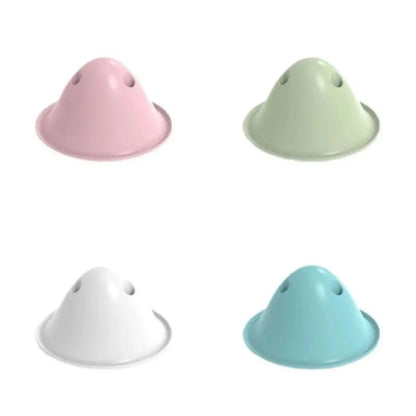 Four coloured interactive dog chew toys with treat slots on smooth surface